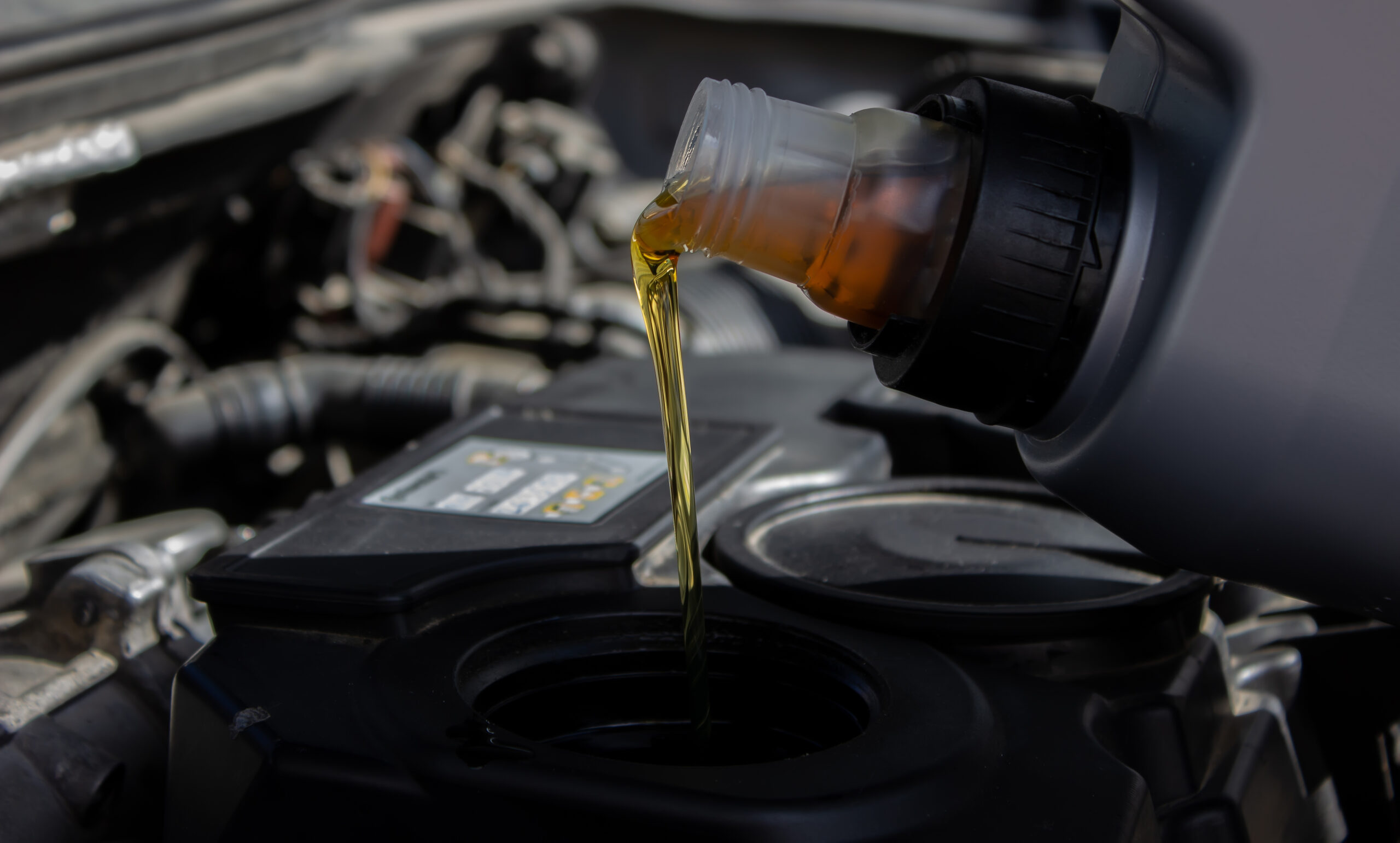 Refueling and pouring oil quality into the engine motor car Transmission and Maintenance Gear .Energy fuel concept. selective focus