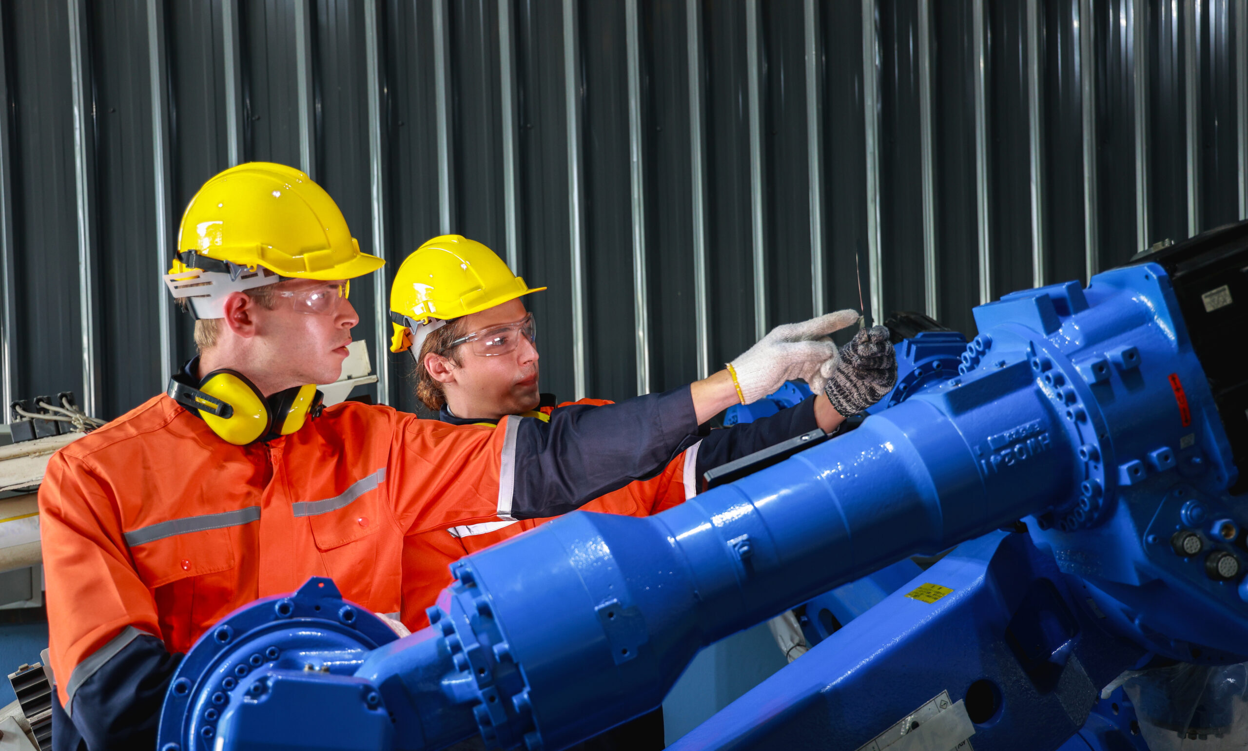 two-caucasian-male-engineers-in-hard-hats-examinin-2025-02-12-03-36-02-utc